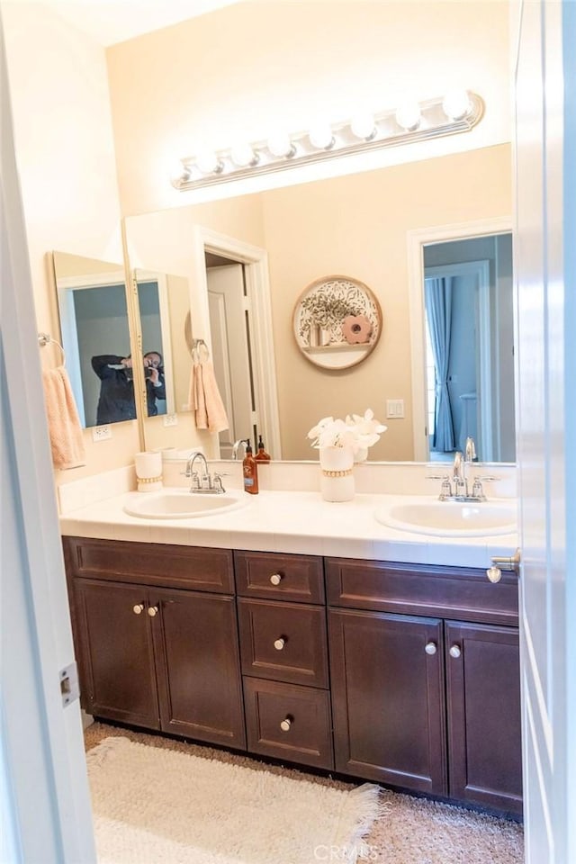 full bath featuring double vanity and a sink