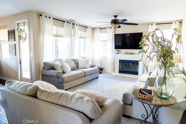 living room featuring carpet floors and ceiling fan