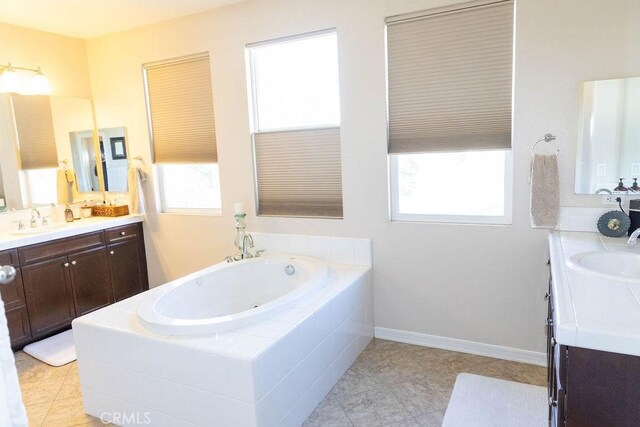 bathroom featuring vanity and a relaxing tiled tub