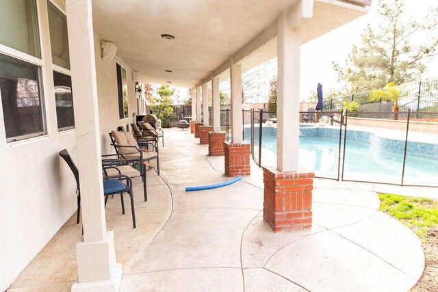 view of patio featuring a fenced in pool