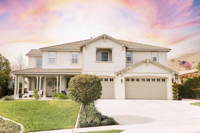 view of front of house featuring a garage and a yard