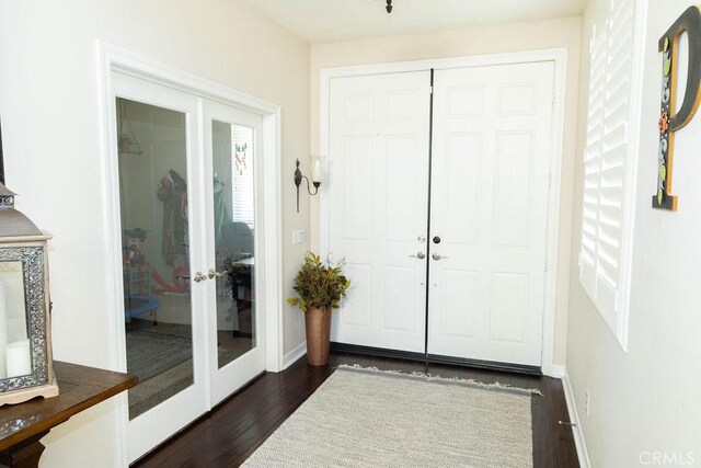 entrance foyer featuring dark wood-type flooring and french doors