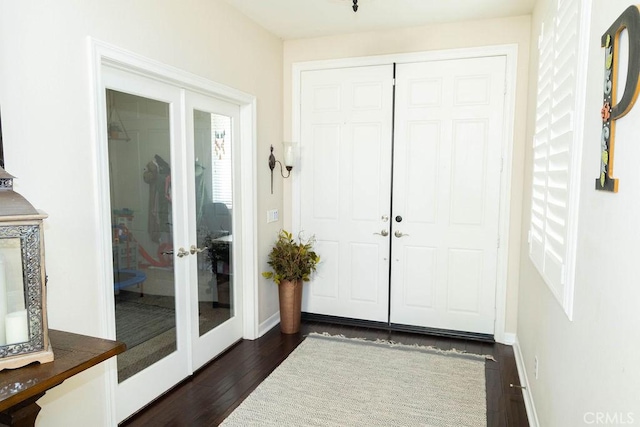 entryway featuring french doors, dark wood-type flooring, and baseboards