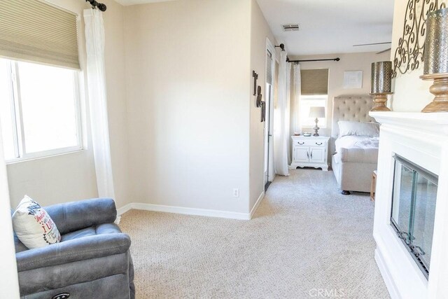 sitting room featuring light carpet and a barn door