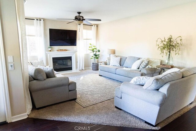 living room with hardwood / wood-style floors and ceiling fan