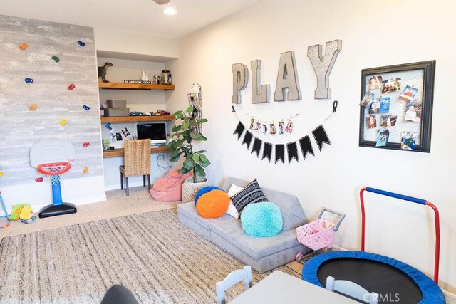 game room with carpet and built in desk