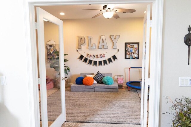 game room featuring ceiling fan and french doors