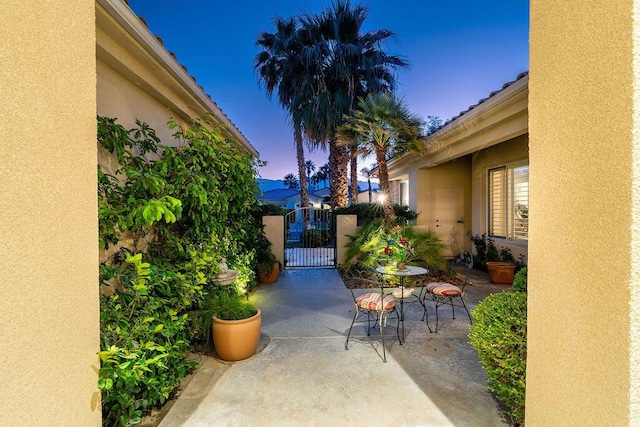 view of patio terrace at dusk