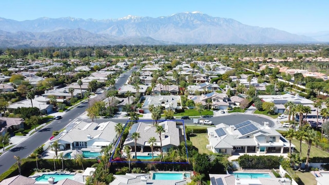 birds eye view of property featuring a mountain view