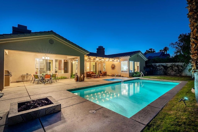 view of pool featuring a fire pit, a patio, and an in ground hot tub