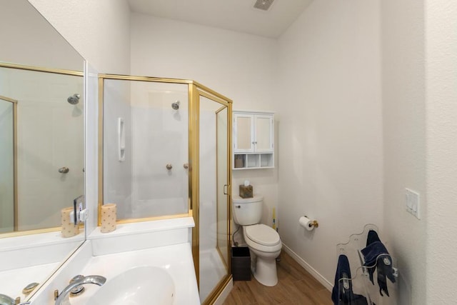 bathroom with sink, hardwood / wood-style flooring, a shower with shower door, and toilet