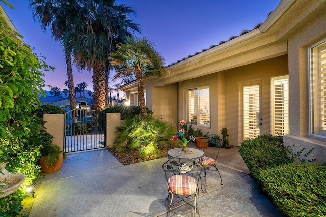 view of patio terrace at dusk