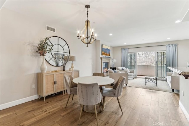 dining room featuring hardwood / wood-style floors and a notable chandelier