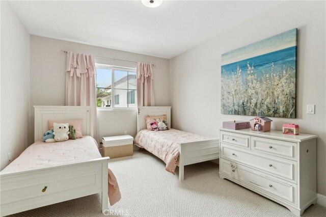 bedroom featuring light colored carpet