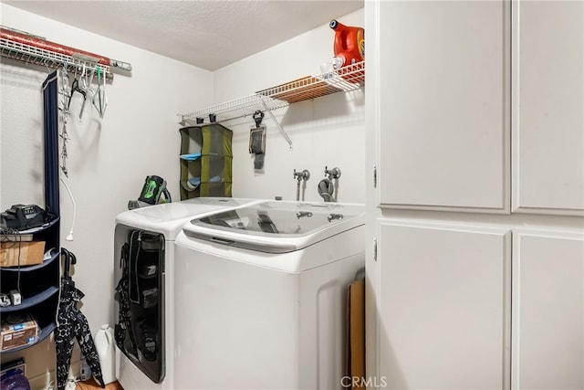 laundry room with washer and dryer and a textured ceiling