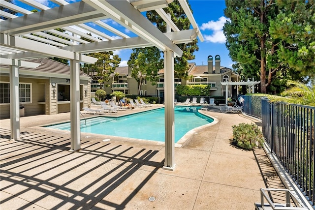 view of swimming pool with a patio area and a pergola