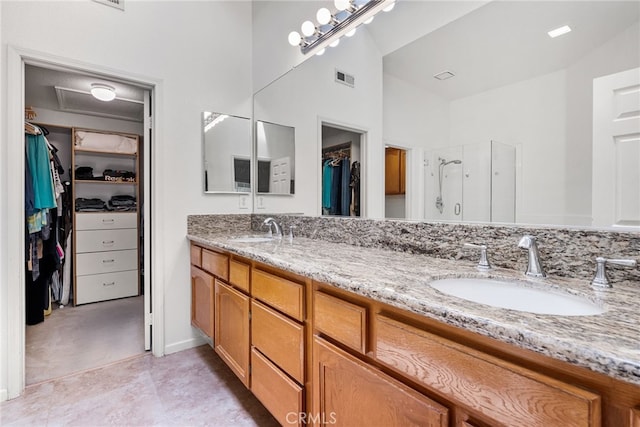 bathroom with walk in shower and vanity