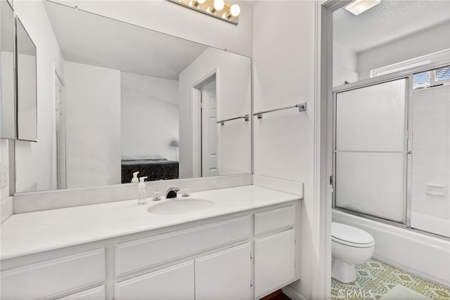 full bathroom featuring vanity, enclosed tub / shower combo, and toilet