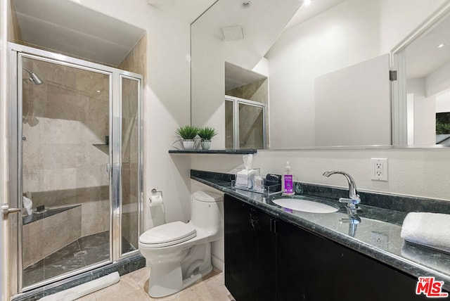 bathroom featuring vanity, an enclosed shower, tile patterned floors, and toilet