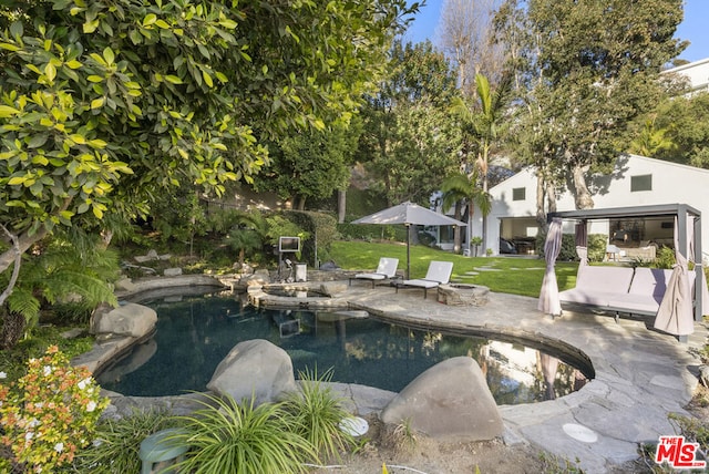 view of pool with a yard, an outdoor hangout area, and a patio area