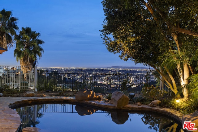 pool at dusk with a mountain view