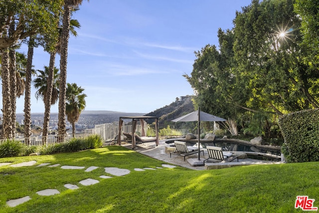 view of yard with a mountain view and a patio