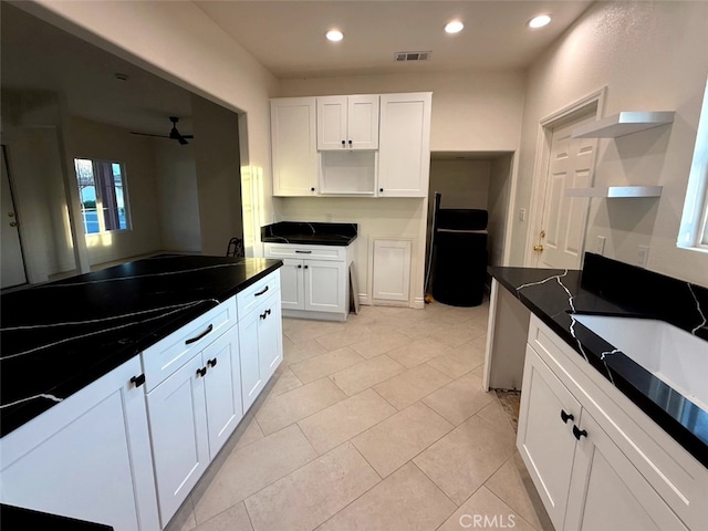 kitchen with white cabinetry, light tile patterned flooring, and ceiling fan