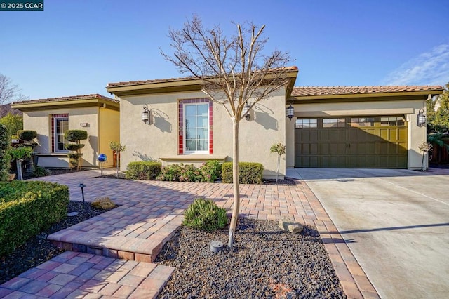 mediterranean / spanish-style house with a garage