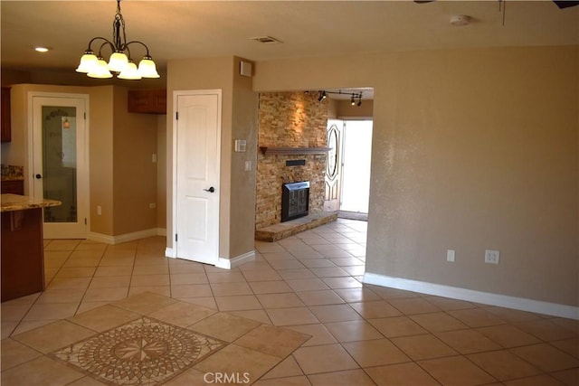 kitchen with hanging light fixtures, light tile patterned flooring, and an inviting chandelier