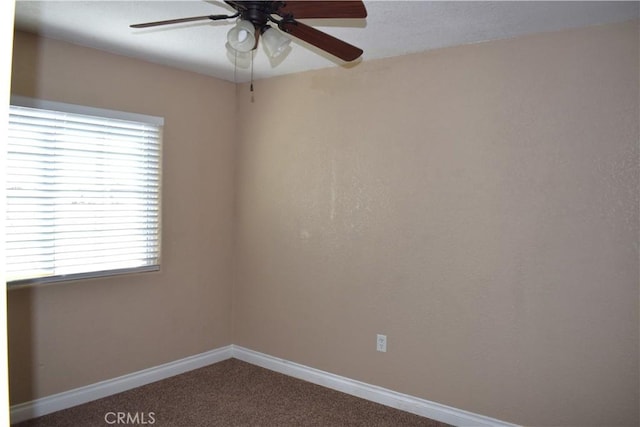 unfurnished room with a wealth of natural light, ceiling fan, and carpet flooring