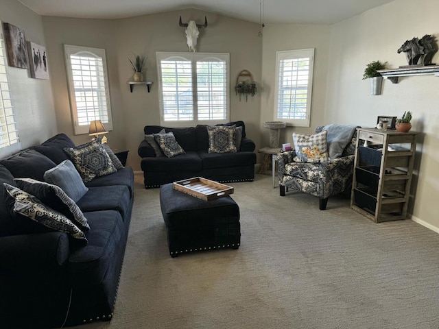 carpeted living room with vaulted ceiling