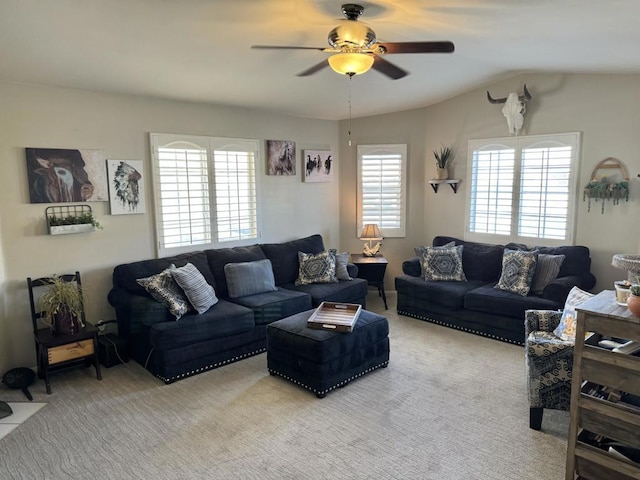 carpeted living room with vaulted ceiling and ceiling fan