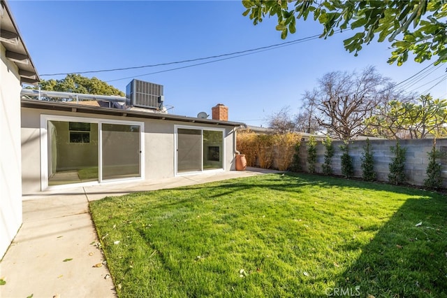 view of yard featuring central AC unit and a patio area