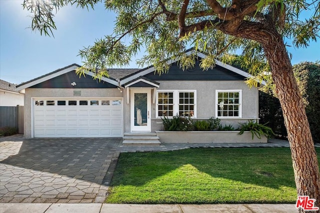 single story home featuring a garage and a front yard