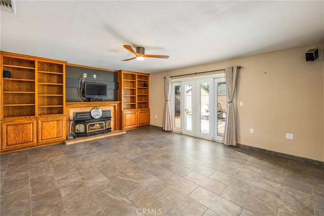 unfurnished living room featuring ceiling fan and french doors