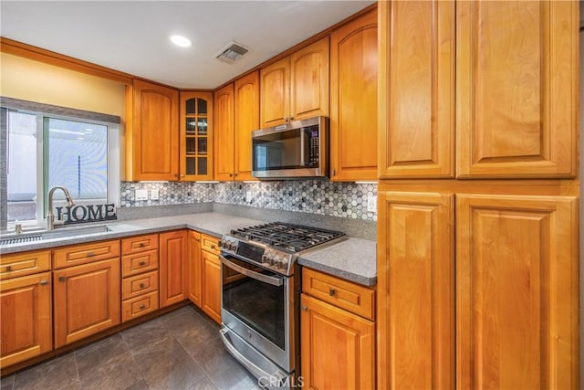 kitchen with tasteful backsplash, stainless steel appliances, and sink