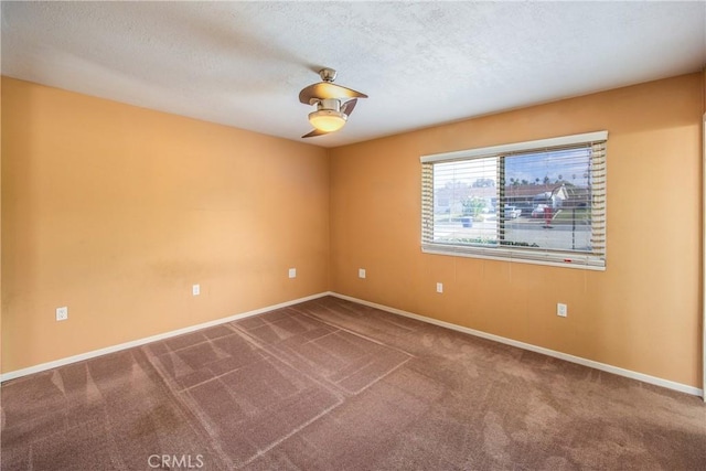 carpeted empty room featuring a textured ceiling