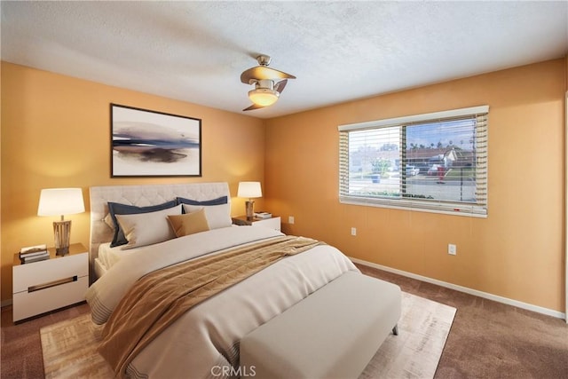 bedroom featuring a textured ceiling, ceiling fan, and carpet