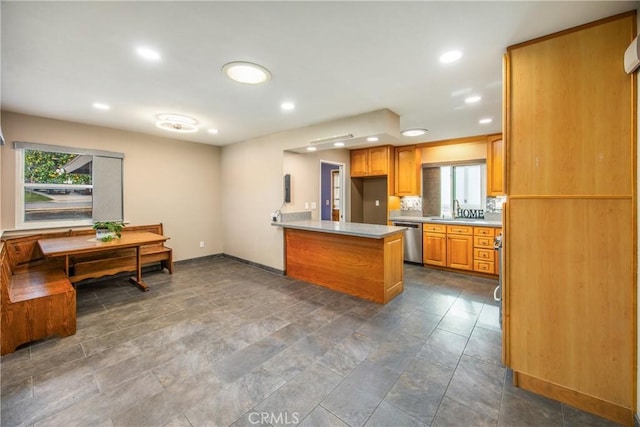 kitchen with dishwasher, sink, and kitchen peninsula