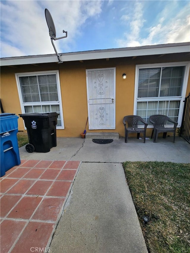 entrance to property featuring a patio