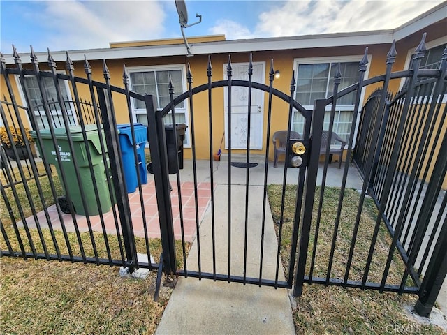 view of gate featuring a lawn