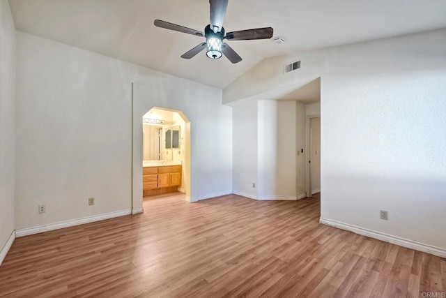 unfurnished room with ceiling fan, lofted ceiling, and light wood-type flooring