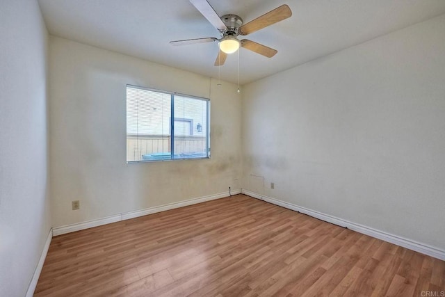 empty room with ceiling fan and light hardwood / wood-style floors