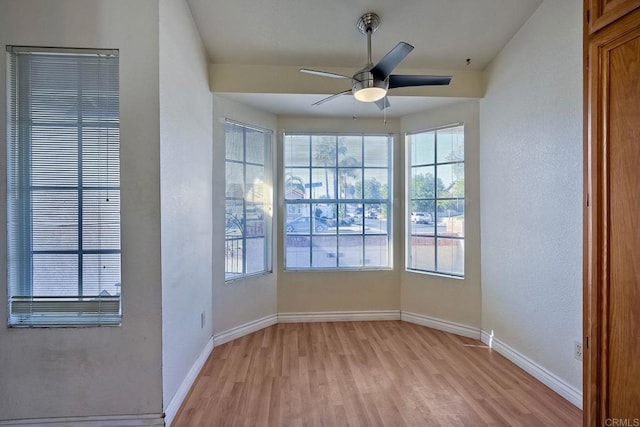 empty room with light hardwood / wood-style flooring and ceiling fan