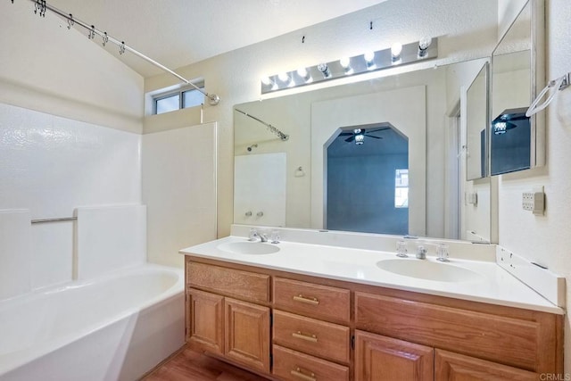 bathroom featuring vanity, bathtub / shower combination, and a wealth of natural light