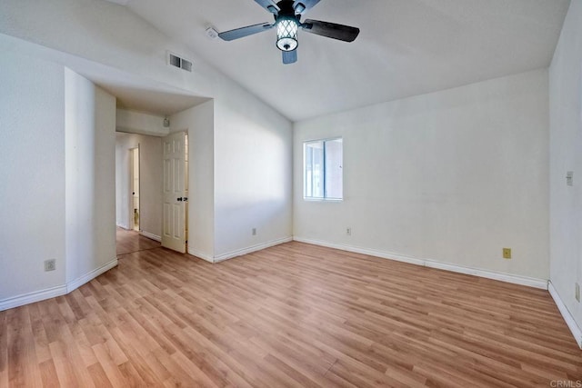 empty room with lofted ceiling, ceiling fan, and light hardwood / wood-style flooring