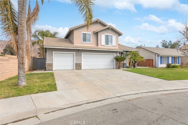 view of property with a garage and a front lawn