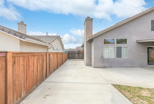 view of side of home featuring a patio