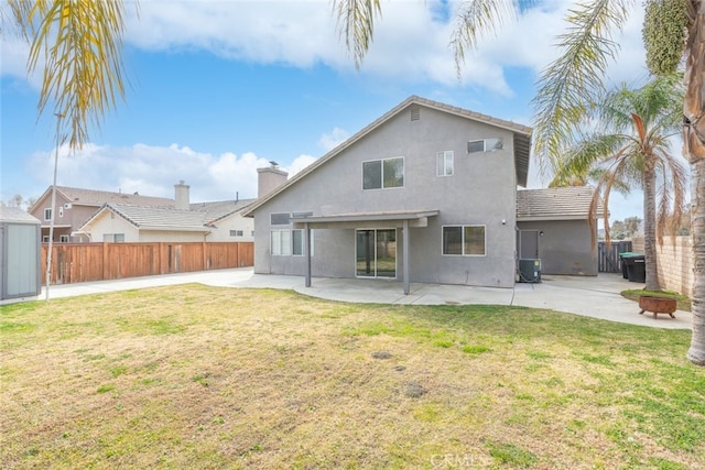 back of property with cooling unit, a patio area, and a lawn