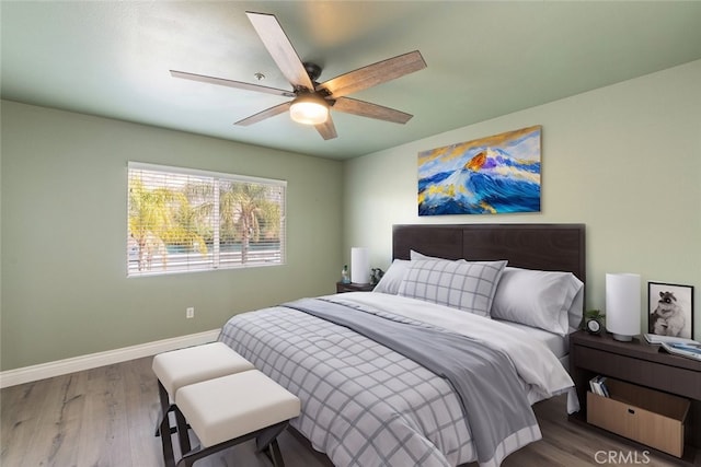 bedroom with wood-type flooring and ceiling fan